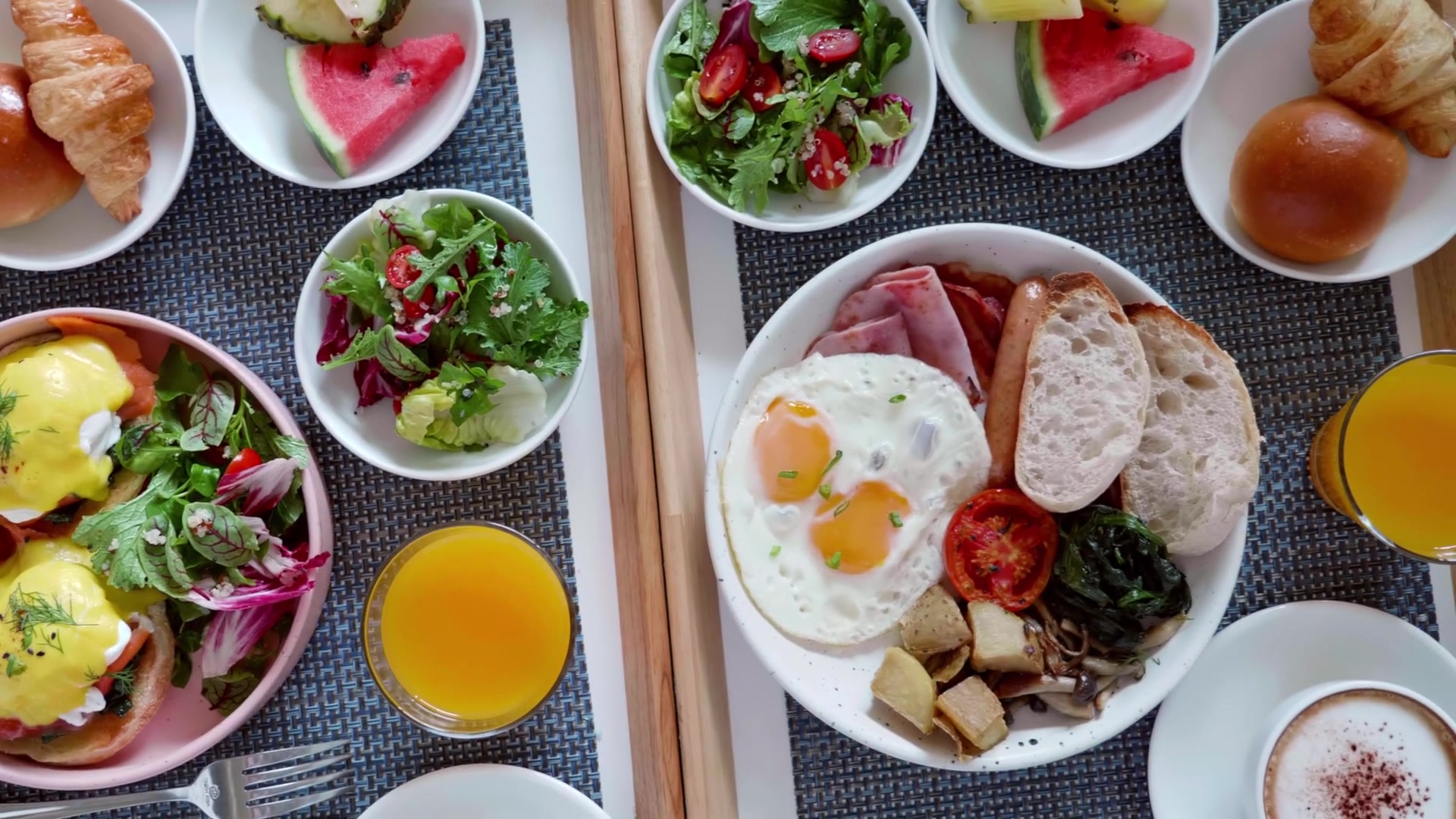 Nutritious home-style breakfast at Colonial Gardens senior dining in Lauderhill FL featuring eggs benedict, fresh salads, orange juice, and croissants