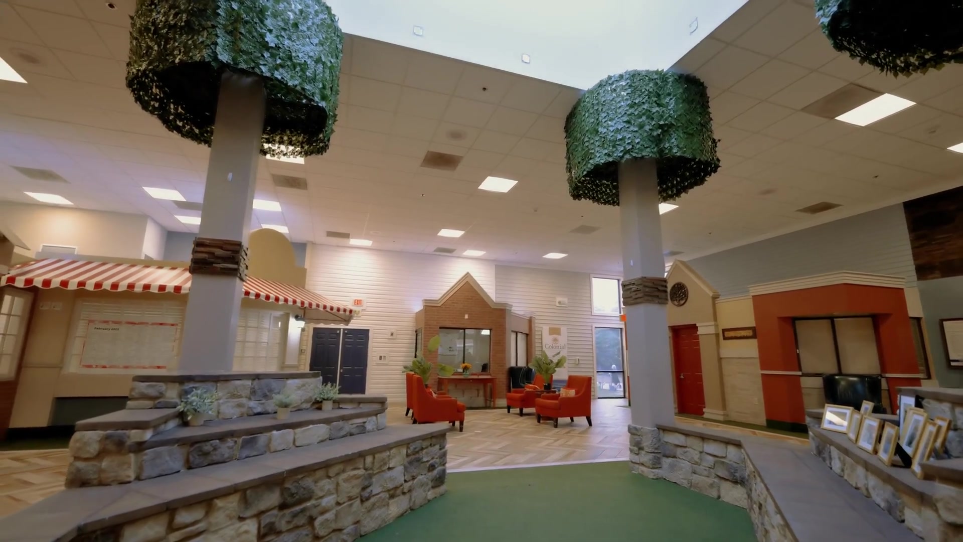 Indoor town square with decorative tree pillars — Colonial Gardens Residences Lauderhill FL